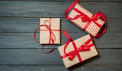 gifts on a wooden background with a red ribbon