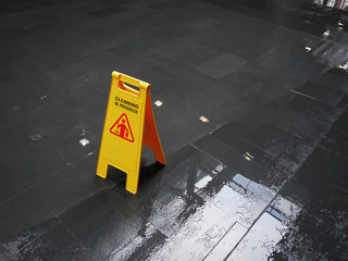Yellow Sign of Cleaning In Progress on Wet Floor