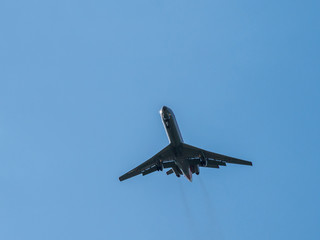 Airplane flying in the blue sky with clouds