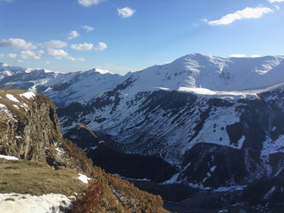 Fototapeta premium View of the beautiful landscape of mountains in the background on a sunny day with a blue sky and clouds in the fall season. red mountains