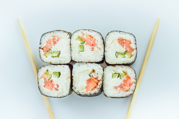 Traditional fresh japanese sushi rolls isolated on white background. Top view