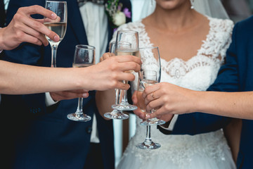 People hold in hands glasses with white wine. wedding party.