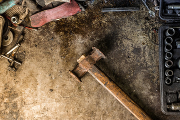 Workshop scene. Old tools in workshop, Tool shelf against a table and wall, vintage garage style. DIY and home improvement banner with work and construction tools on a metal workbench top view.