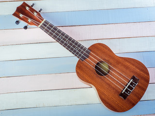 Close up of ukulele on old wooden background