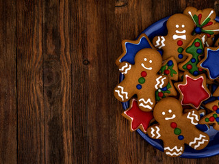 Happy New Year and Merry Christmas gingerbread on wood background. Christmas baking. Making gingerbread christmas cookies. Christmas concept.	
