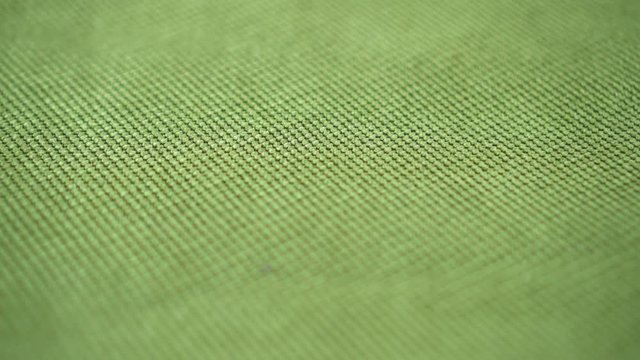 Textured green fabric extremely close up