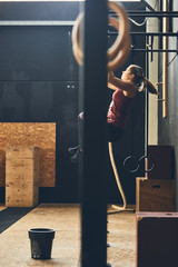 Workout woman pull ups exercise in gym