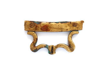 Antique bronze handle on white. Beautiful gold color decorative element close-up photo