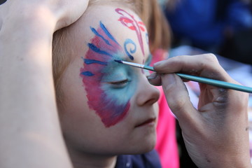 Painting on the face of a young girl.