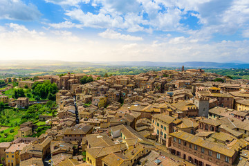 Fototapeta na wymiar Historic town Siena, Tuscany - Aerial view with beautiful landscape scenery on a sunny summer day, walled medieval hill town with towers in the province of Siena, Italy- Europe
