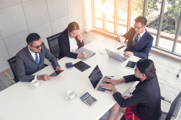 Cheerful business people met for briefing and discuss plans of strategy of company in sunny nice workplace