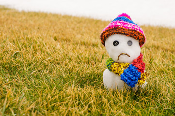 Sad snowman with hat and scarf