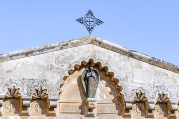 Statue of an angel on the roof of a building in the courtyard of Church of the Condemnation and...