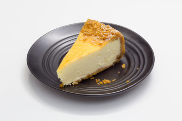 Cheesecake on black saucer