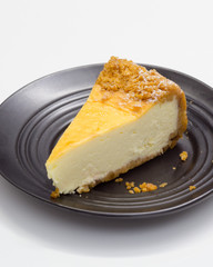 Cheesecake on black saucer