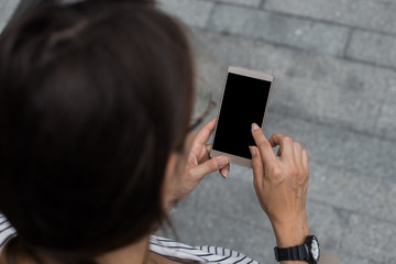 Cropped shot view of womans hands holding smart phone with blank copy space screen for your information content about app, logo or copy, using free wifi or 4G Internet abroud. App for taxi servises