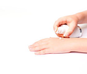Children's hands and cream in a white tube. On white background. Baby skin care.