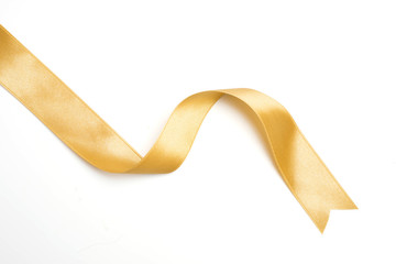 Gold ribbon in roll on white