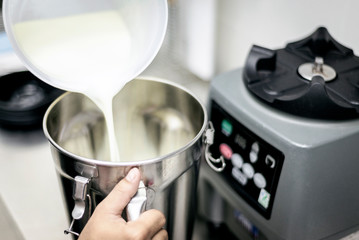 making gelato ice cream with modern equipment in kitchen interior