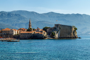 Fototapeta na wymiar View of the city of Budva in the morning from the shore, on the horizon of the mountain