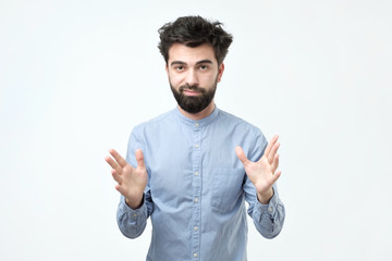 Handsome young man explaining something and gesturing with his hands