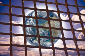 The world seen through a metal grate of a prison - concept image with image from NASA