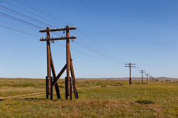 overhead line on wooden supports in the Mongolian steppe