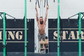 young man training indoor crossfit gym gymnastic rings - sportive, training, healthy lifestyle...