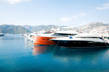 Fototapeta premium Large yachts on the sea against the background of mountains. Concept of yachting and recreation on yachts.