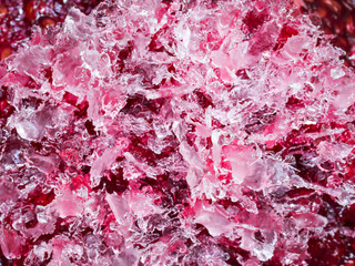 Texture of pink frozen water crystals, close up, top view