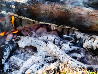 Smoldering ashes of bonfire, extreme close up