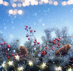 Art Christmas tree and holidays light decoration on blue snow background