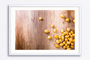 Potatoes on rustic wooden table. Raw potato.