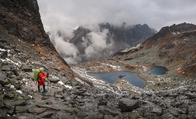 Female hiker climbing up the Rysy mountain