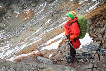 Female hiker climbing up the Rysy mountain