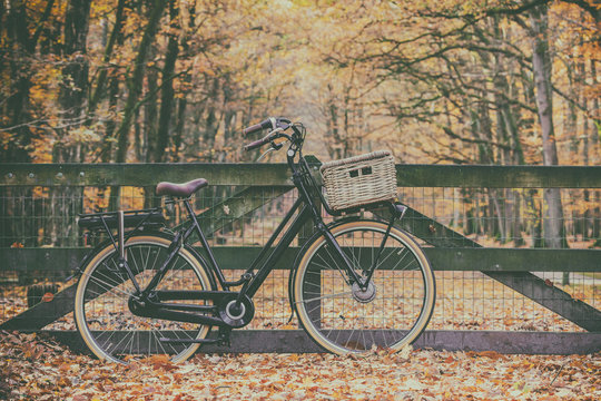 Retro styled image of an electric cargo bicycle in autumn