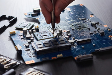 Technician plug in CPU microprocessor to computer motherboard
