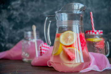 Lemonade watermelon and lemon in a glass carafe. The concept of a refreshing drink in the summer.