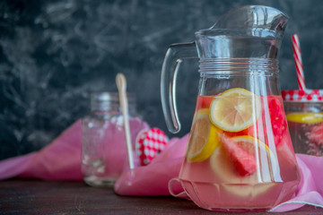 Lemonade watermelon and lemon in a glass carafe. The concept of a refreshing drink in the summer.