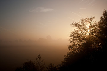 Fototapeta na wymiar Foggy sunrise in local landscape