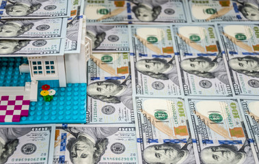 toy house with a roof of dollars