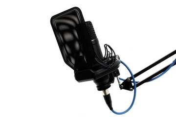 Professional studio microphone with plugged in XLR connector on white background