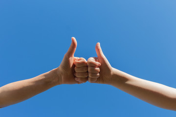 close up couple of helping praying hands on blur beautiful sunrise sky background for save and support people concept..