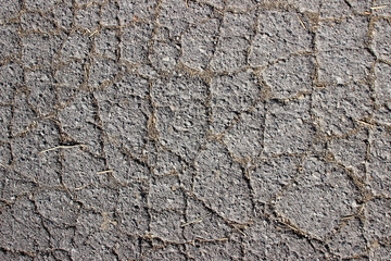 Naklejka premium Old asphalt surface texture detail with cracks fractures lines close up