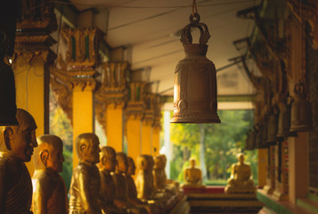 A row of golden buddha statue at Wat Intharam Kanchanaburi, Thai