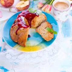 A bouquet of fresh tulips. Sweet home cupcake with sugar. Coffee in a cup. Apples on the table.