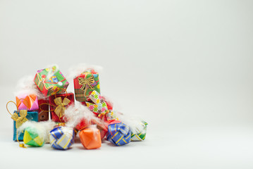 Closeup pile of  gift boxes wrapped by colorful paper for Christmas festival with isolated background. Selective focus of presents in beautiful package for giving in any occasion.