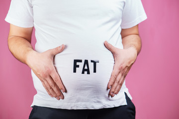 overweight, overeating, gluttony. Fat man with big belly, close up.