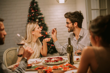 Friends celebrating Christmas or New Year eve at home