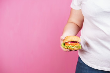 weight loss, overweight, plus size, diet, unhealthy eating. fat woman with fresh hamburger